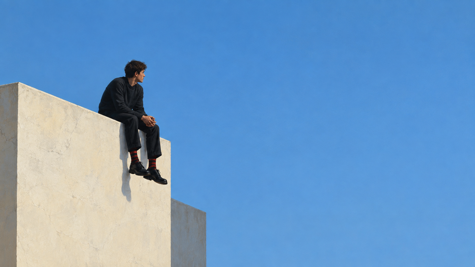 A minimalist, realistic painting of a solitary figure sitting on the edge of a pale, textured buildi
