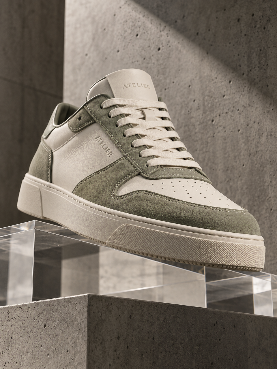 Product Photography. "ATELIER". A luxury sneaker in cream and sage green, shot from a dramatic low a